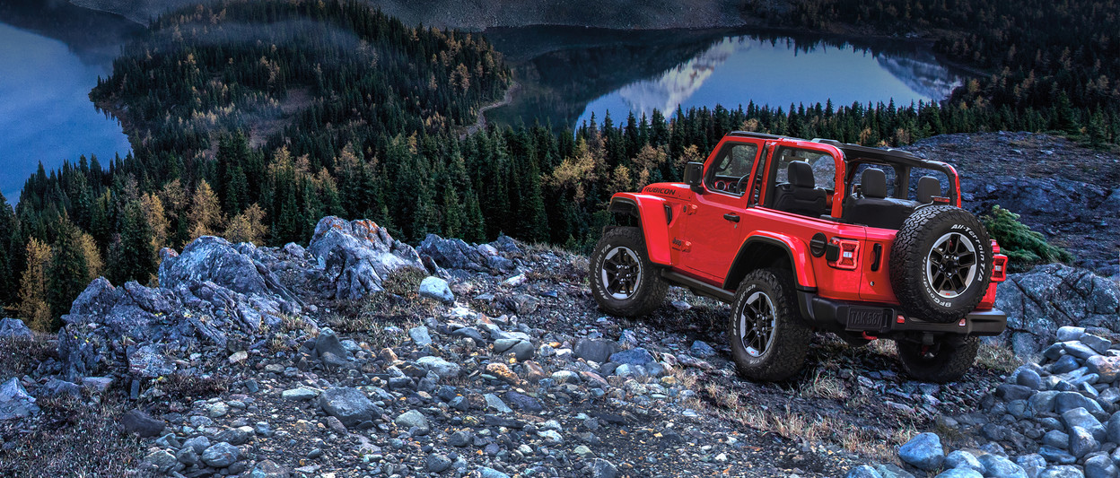 2019 Jeep Wrangler on river bed, shown in red