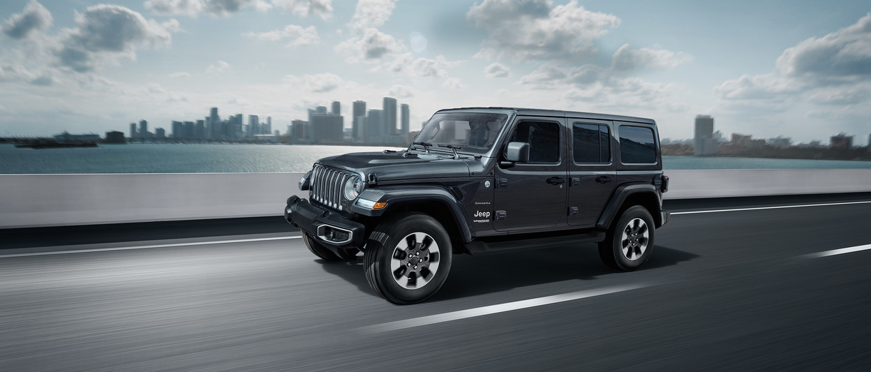 2019 Jeep Wrangler on highway, shown in dark grey