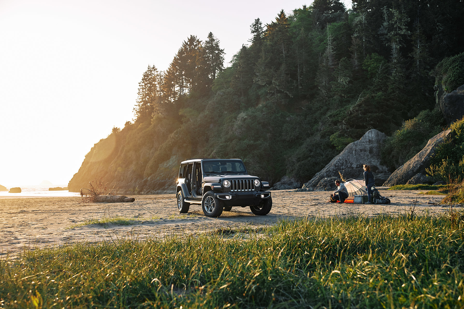 2021 Wrangler parked on a rugged shortline beside a campsite.