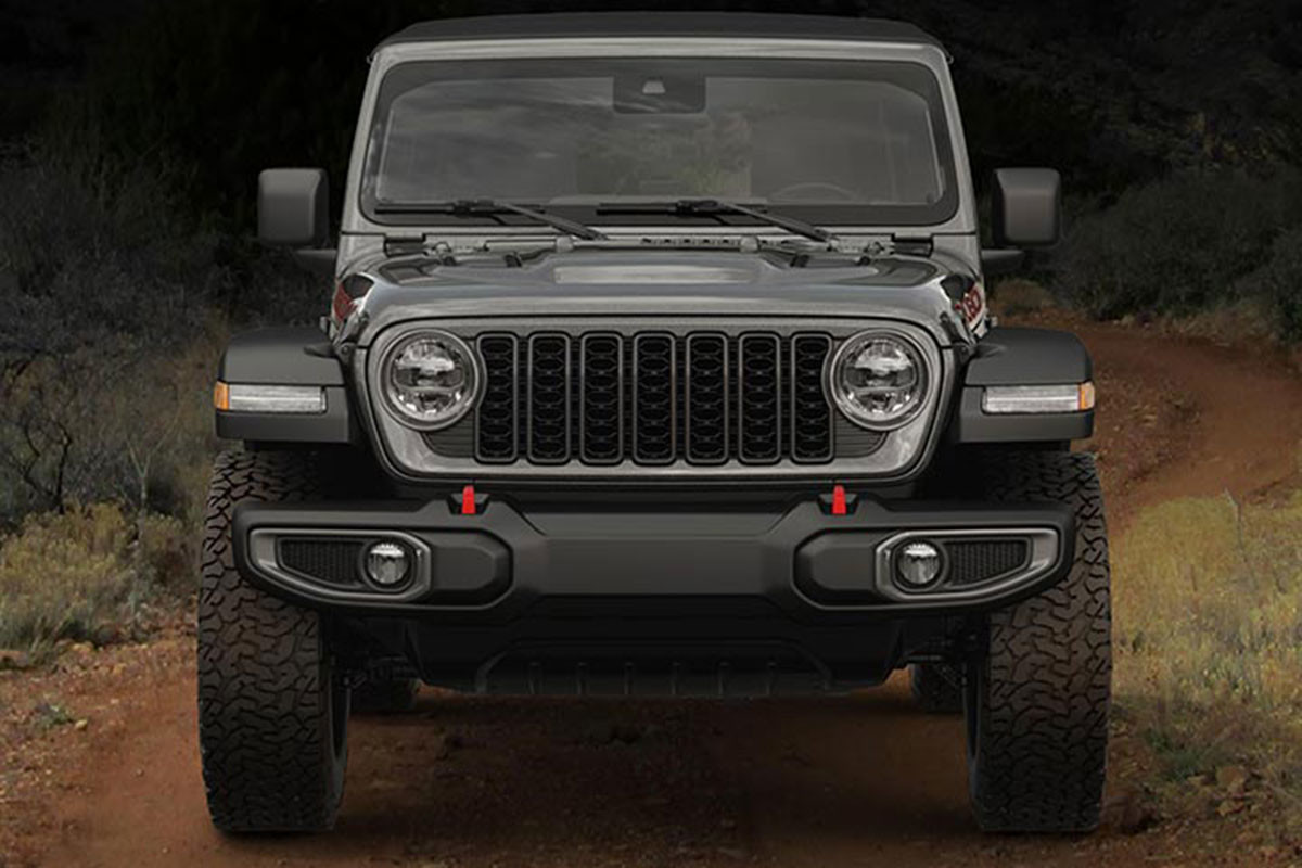 Front view of a 2024 Jeep Wrangler with black background.