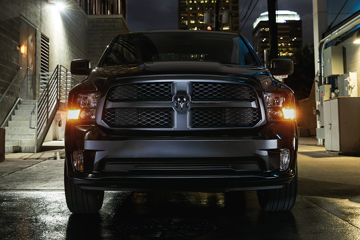 Front view of the black 2020 Ram 1500 Classic parked in an alleyway at night