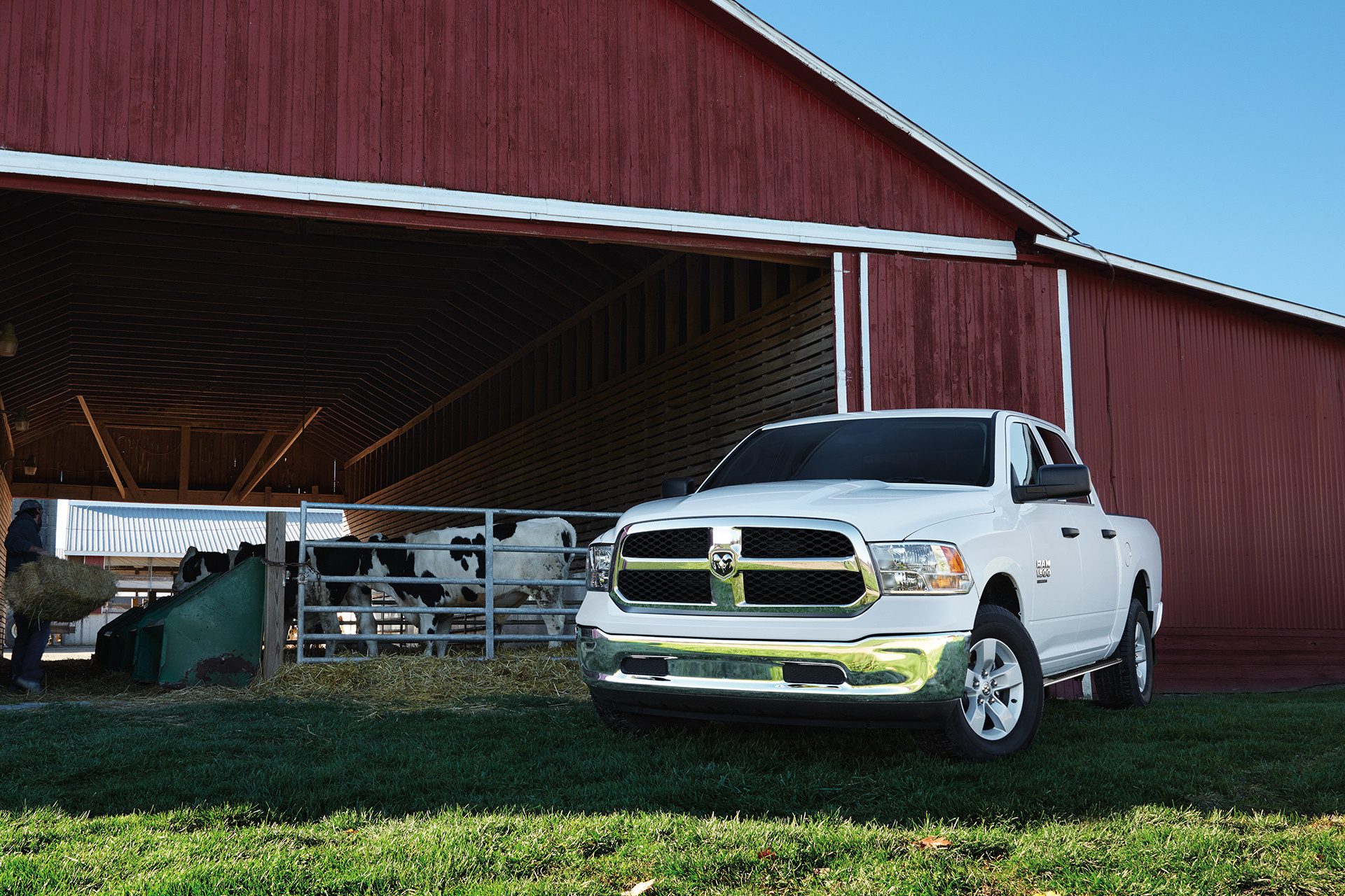 Front view of the white 2020 Ram 1500 Classic parked in front of a barn on grass