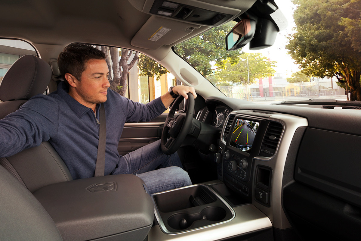 A person using the ParkView Rear Back-up Camera to reverse, in a 2022 Ram 1500 Classic.
