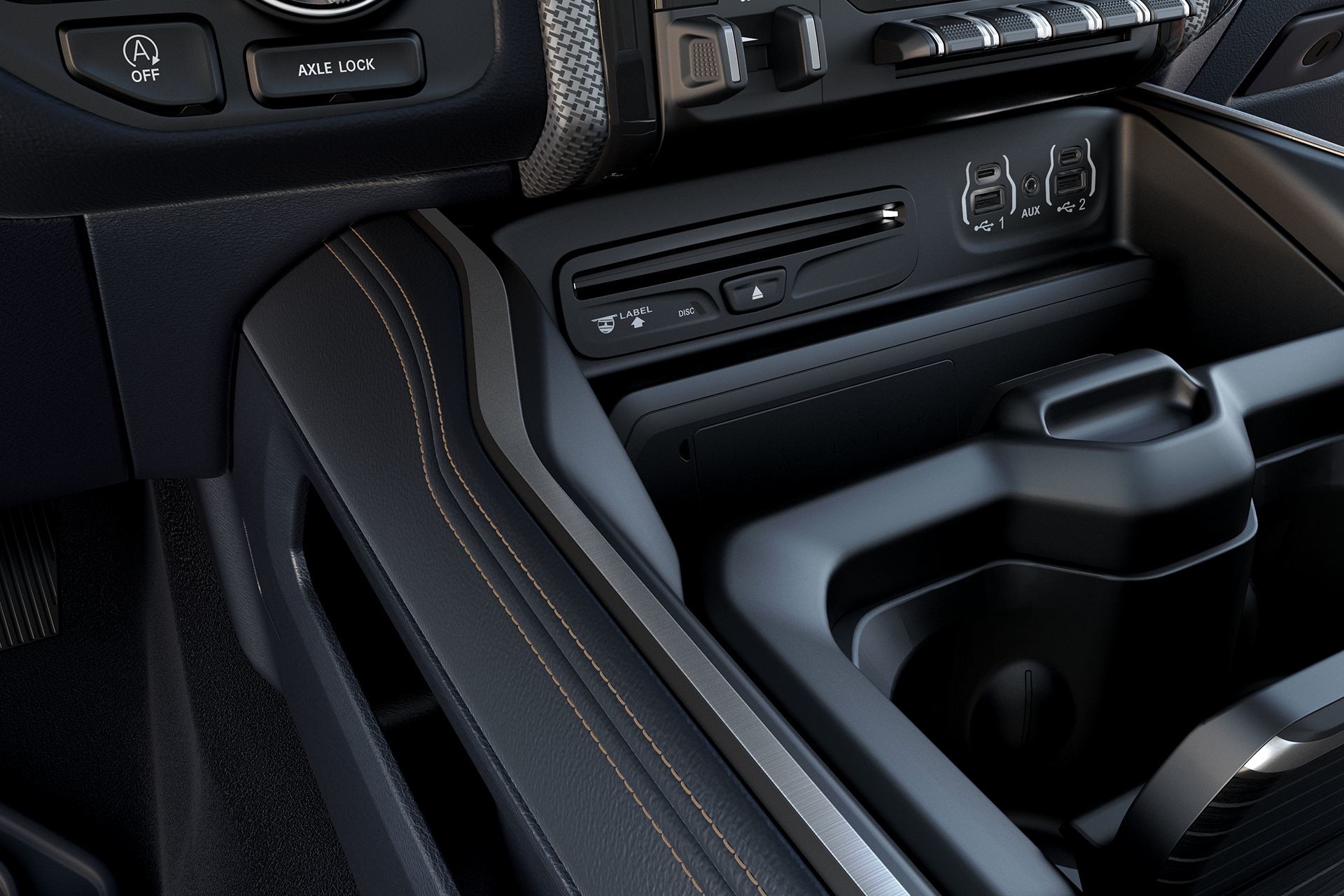 Interior shot of the storage compartment of the 2019 Ram 1500, showing USB ports and an AUX port