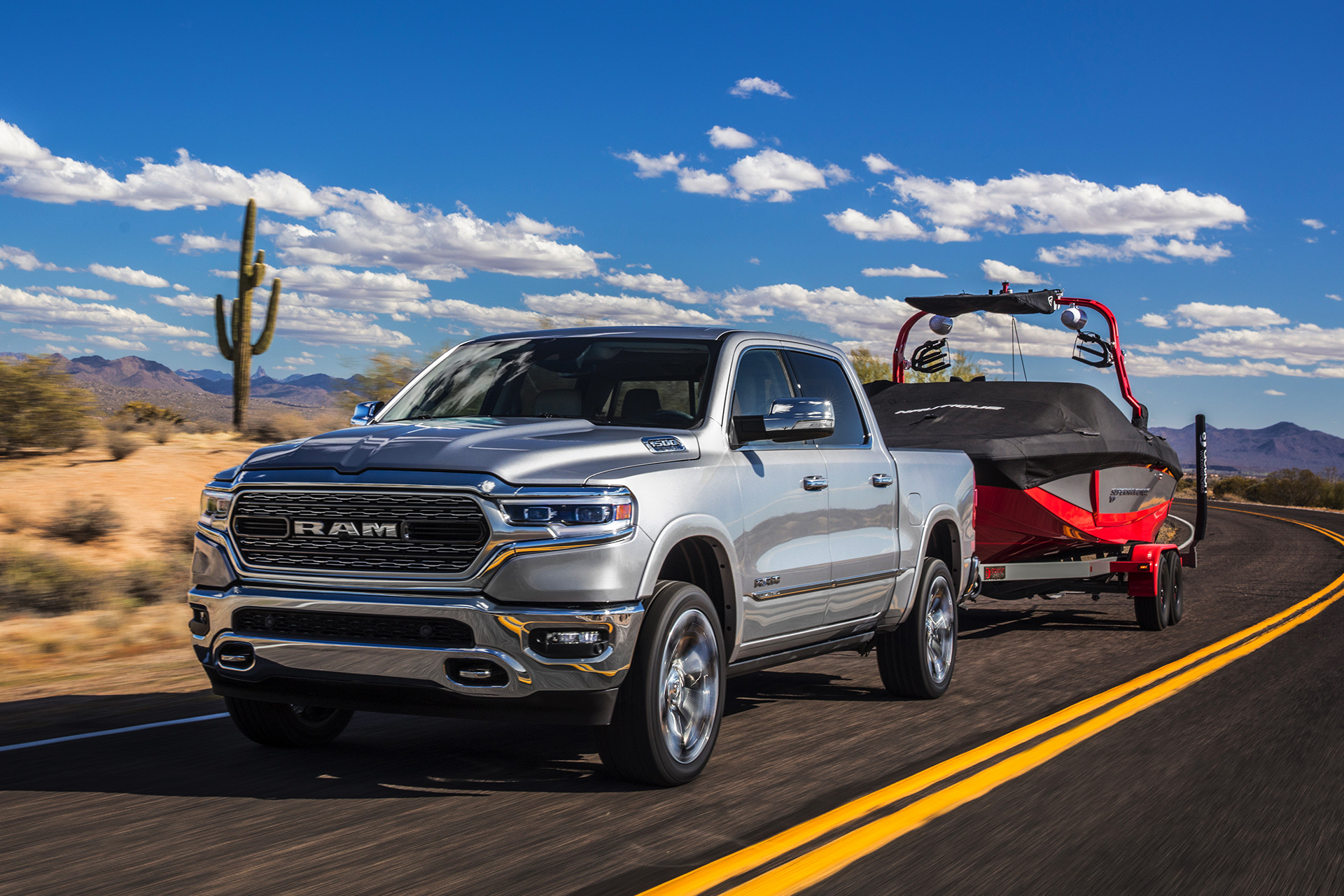 Silver Ram 1500 DS Driving Through the Desert Carrying a Red Boat