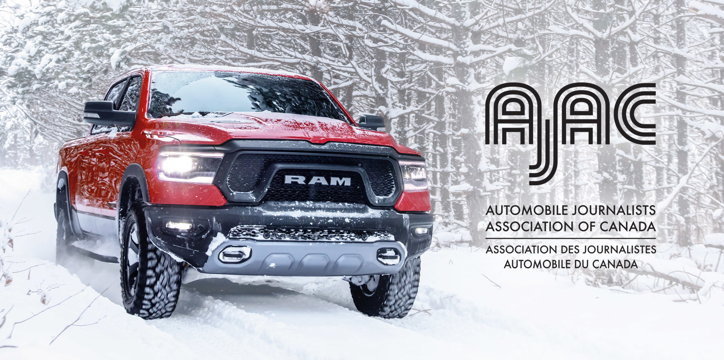 Red Ram 1500 DT driving on a snowy trail, alongside snow-covered trees. AJAC. Automobile Journalists Association of Canada. Association des journalistes automobile du Canada.