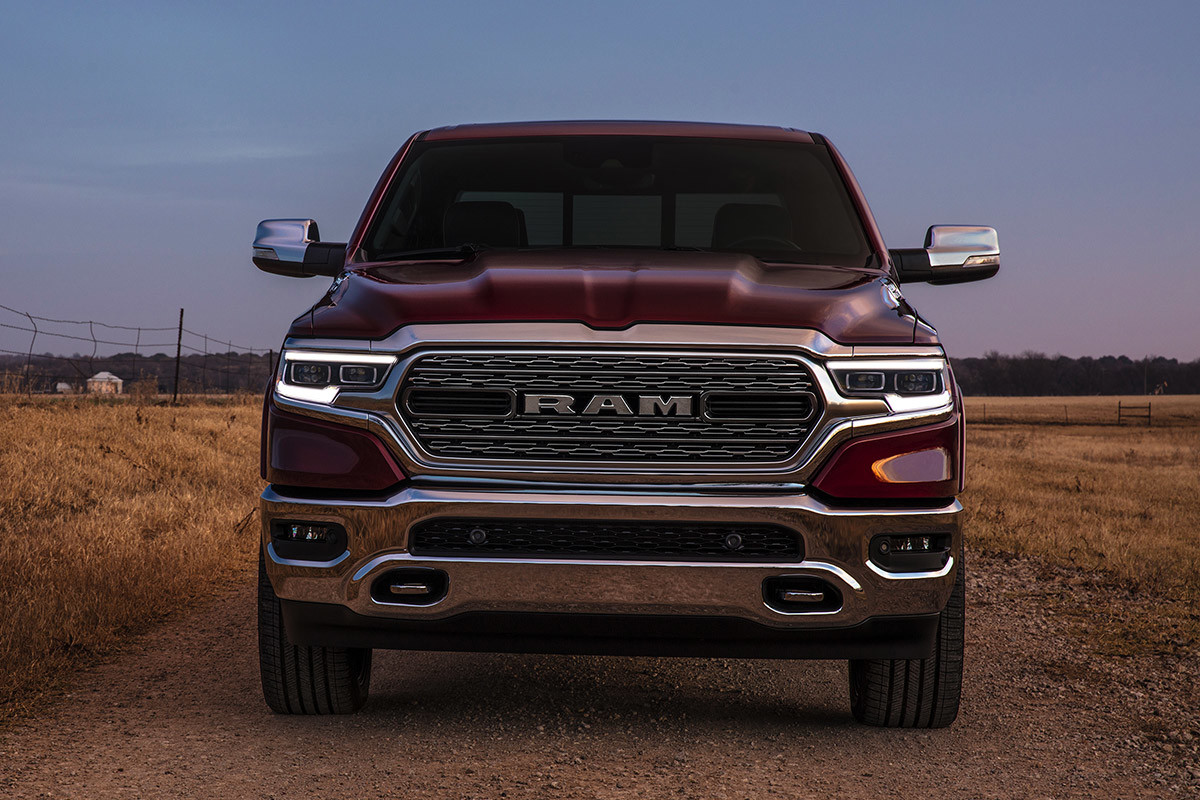 Dark red 2020 Ram 1500 driving through a dirt road