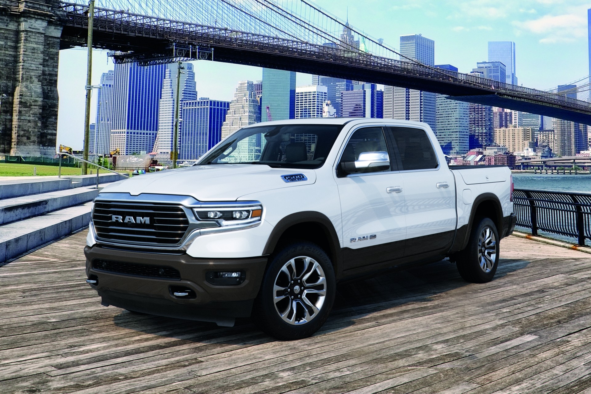 White 2021 Ram 1500 parked beside river.