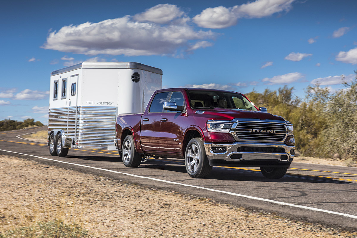 Red 2022 Ram 1500 towing a large enclosed trailer