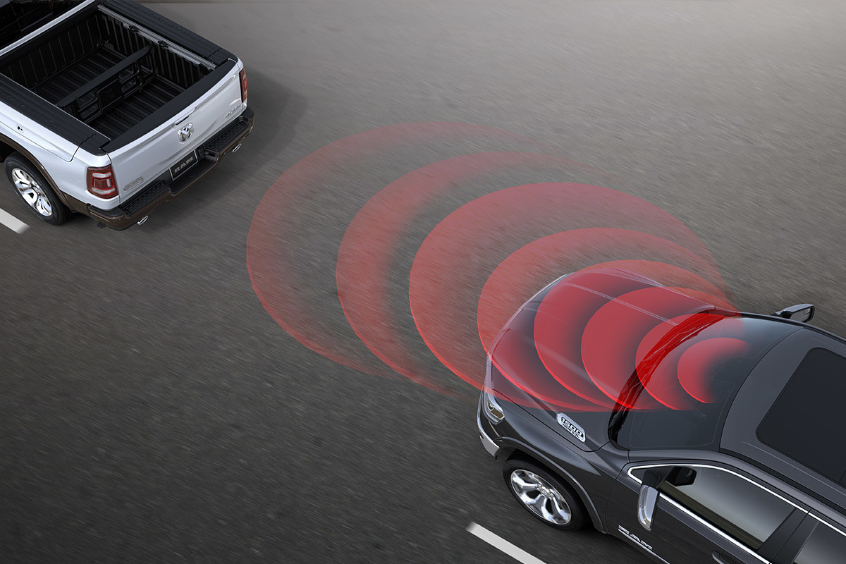 2022 Ram 1500 driving on highway. Concentric circle graphically represent sensors detecting vehicle ahead