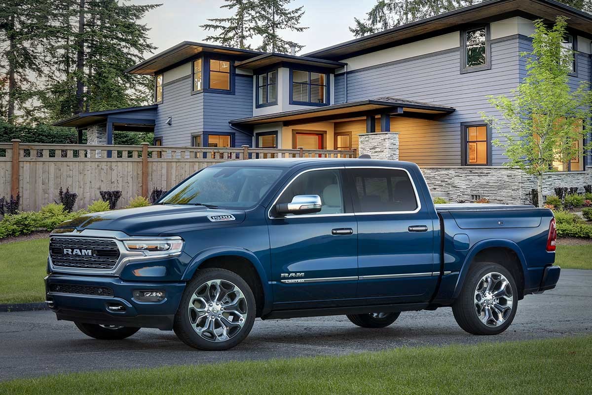 2022 Ram 1500 Limited 10e Anniversaire en bleu de prusse garé dans l'allée devant la maison.