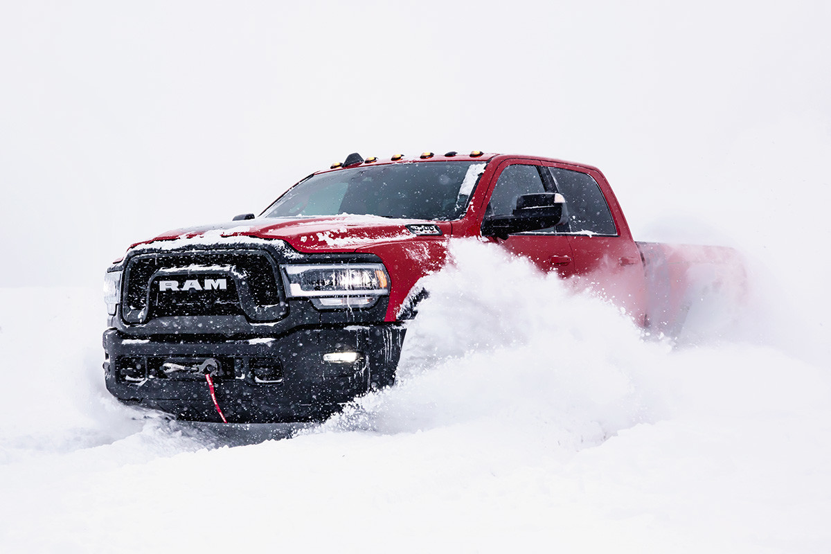 Front view of the red 2020 Ram 2500 Rebel drving through the snow