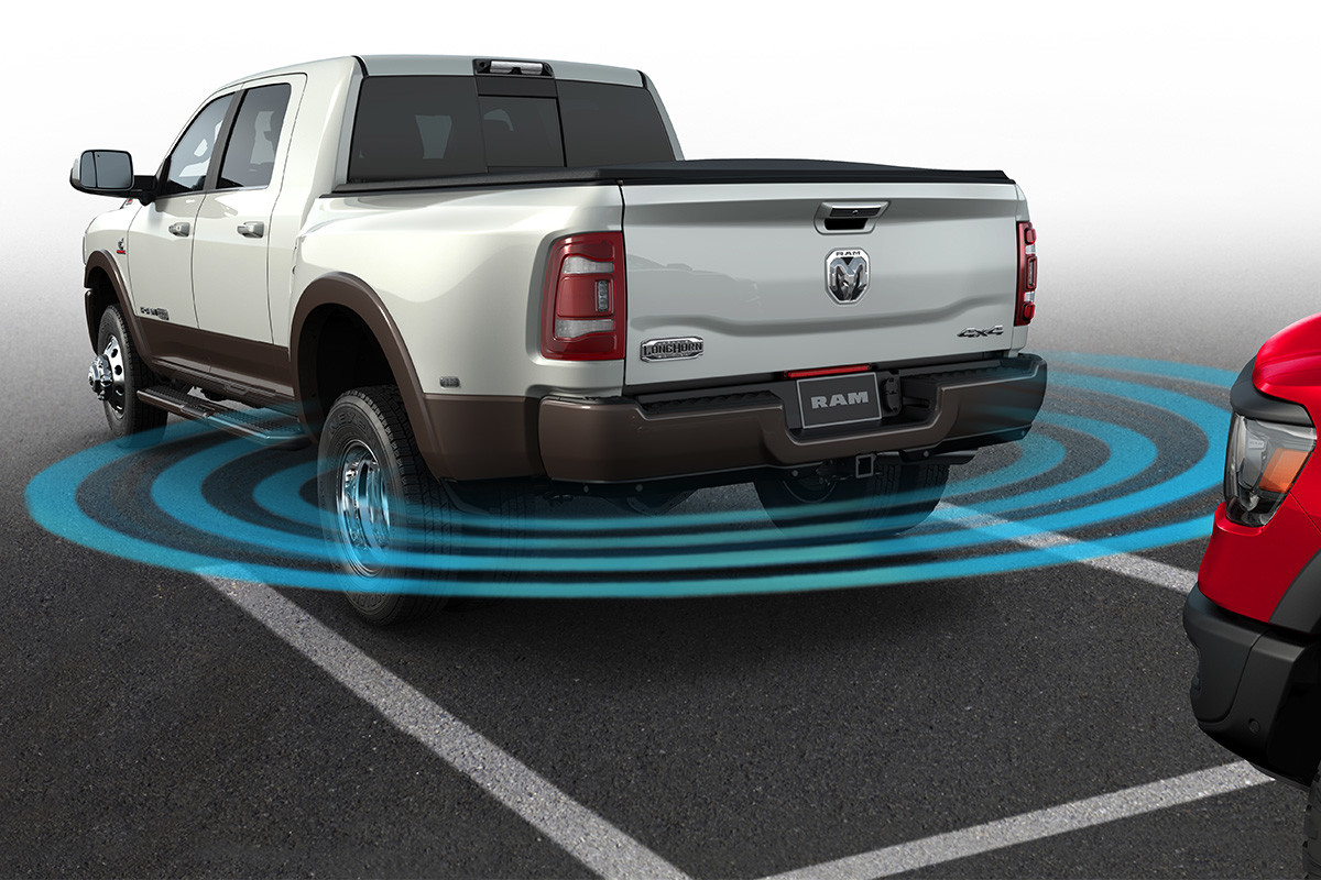 Rear quarter view of the new 2019 Ram 2500 white highlighting 360 view and parking assistance feature