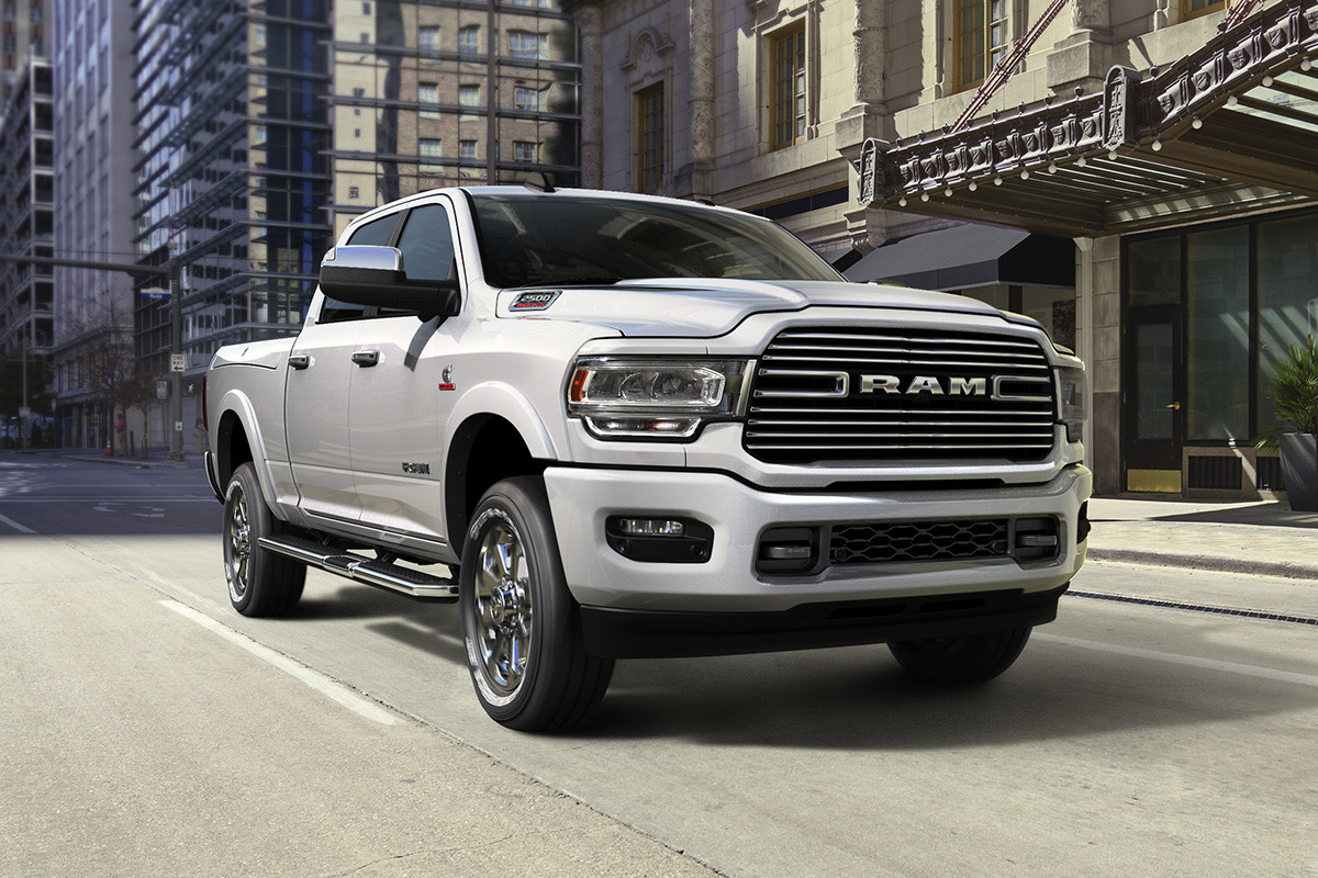 Front quarter view of the new 2019 Ram 2500 white being driven on a city street
