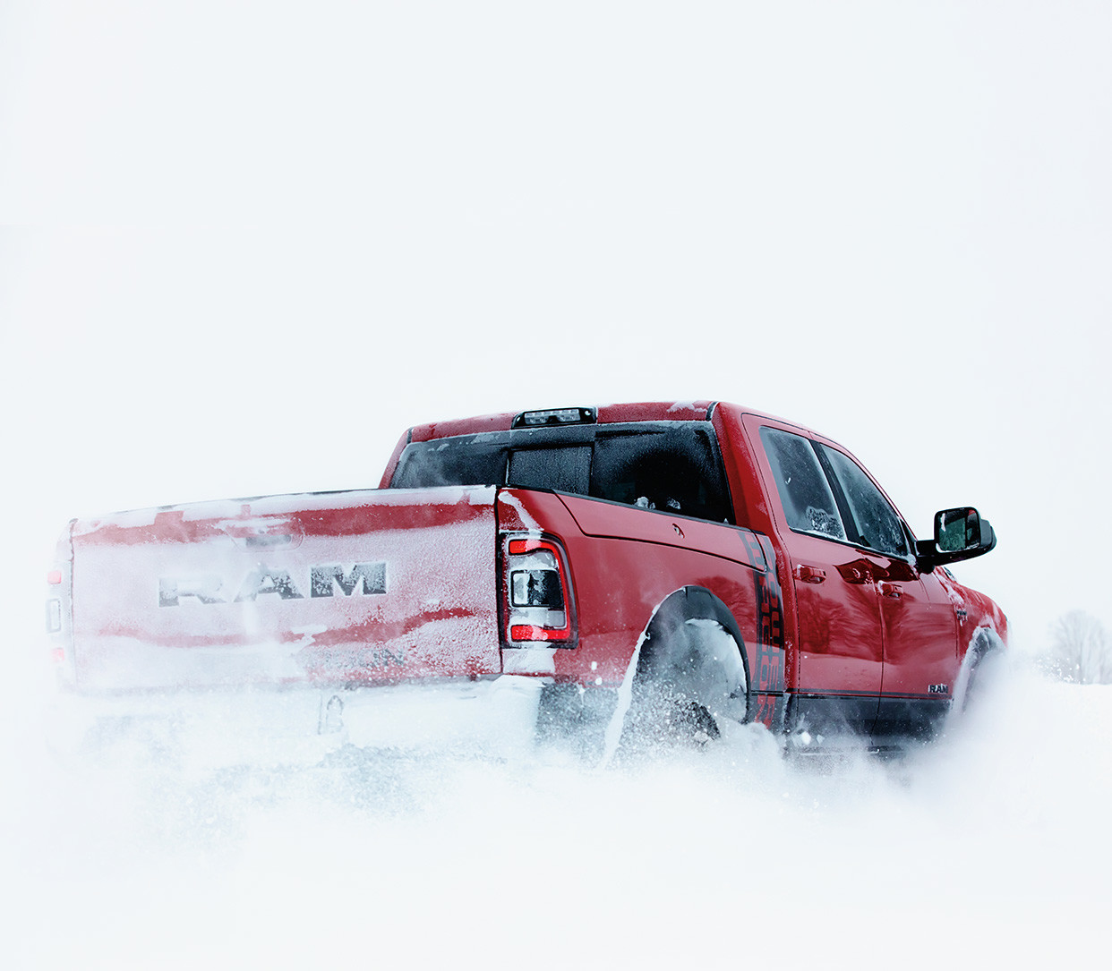 Front three quarter view of the new 2019 Ram 2500 in patriot blue pearl colour being driven on a country road