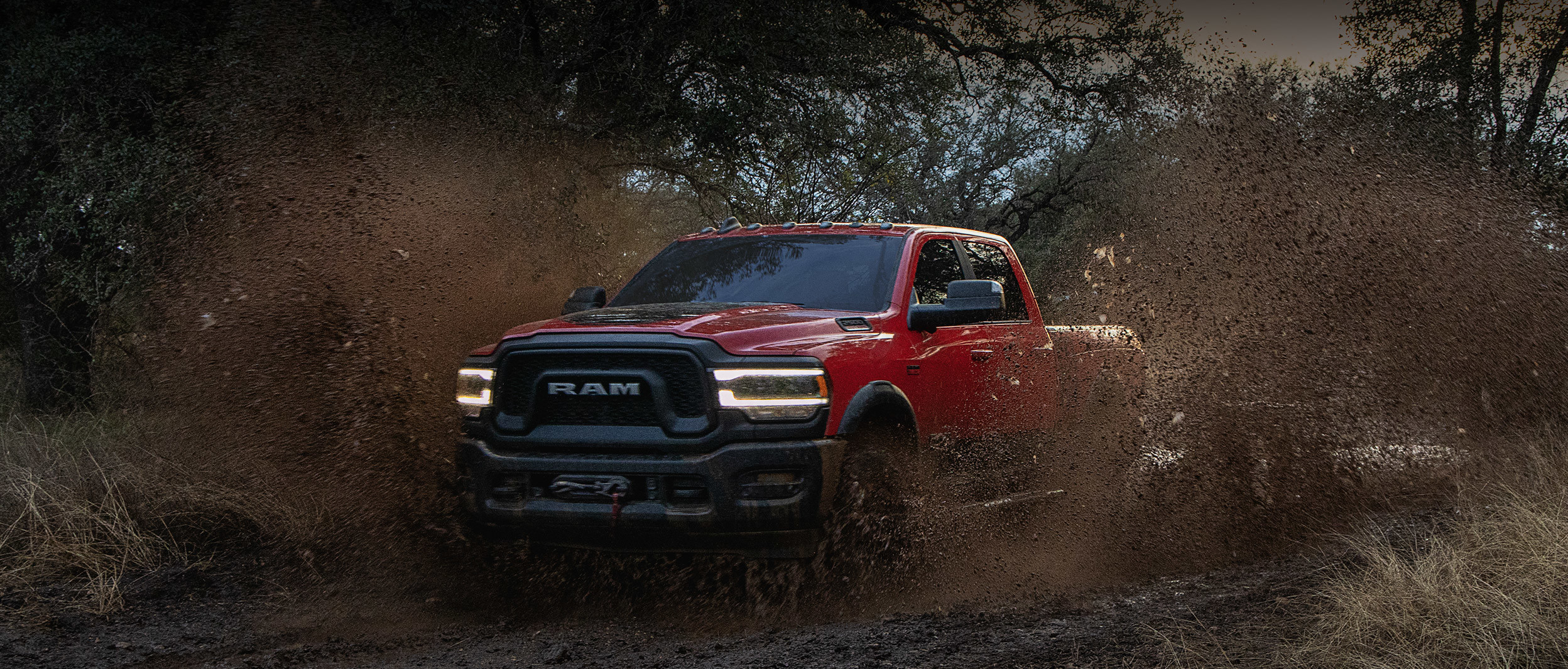 The 2020 Ram 2500 passing the muddy road through trees