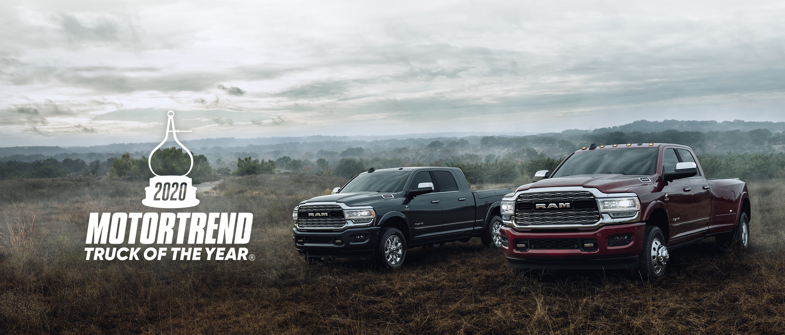 The 2020 Ram 2500 and 1500 parked on in the grass.