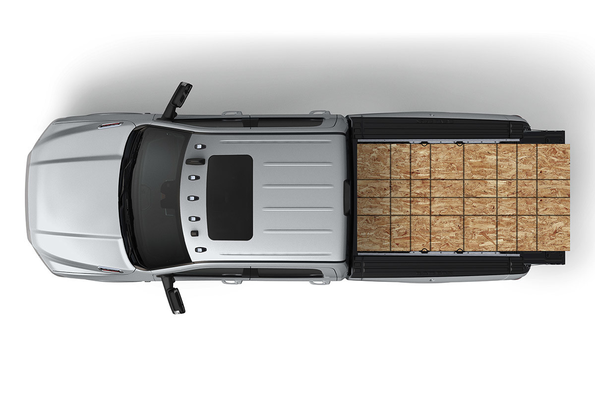 Aerial shot of a Ram 2500 with full sheets of plywood in the cargo bed.