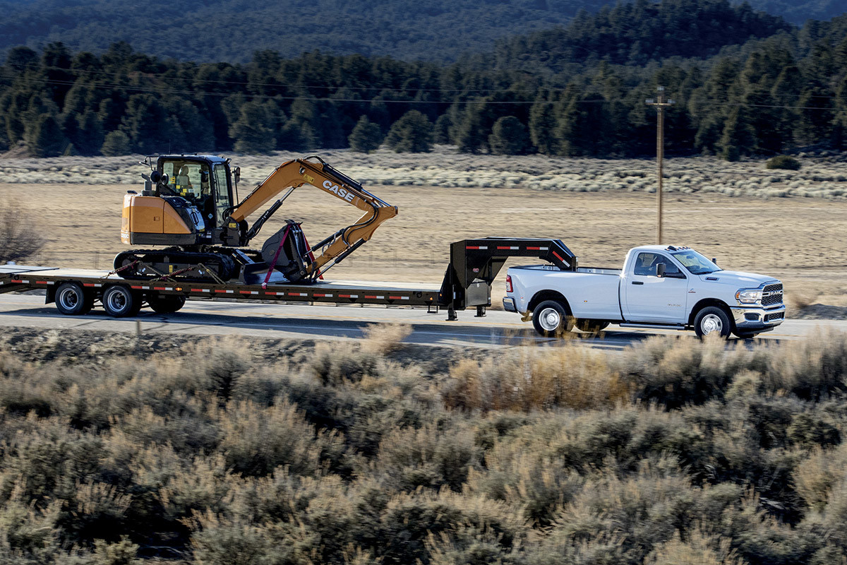 A 2022 Ram 2500, towing an excavator on a flatbed.