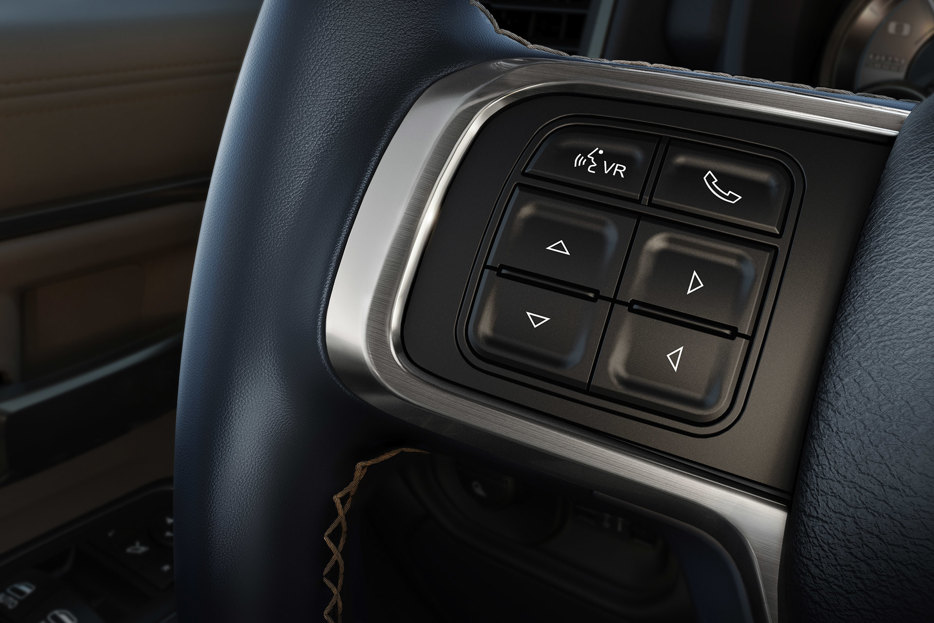 Control buttons that operate the UConnect multimedia system on the steering wheel of a 2020 Ram 3500.