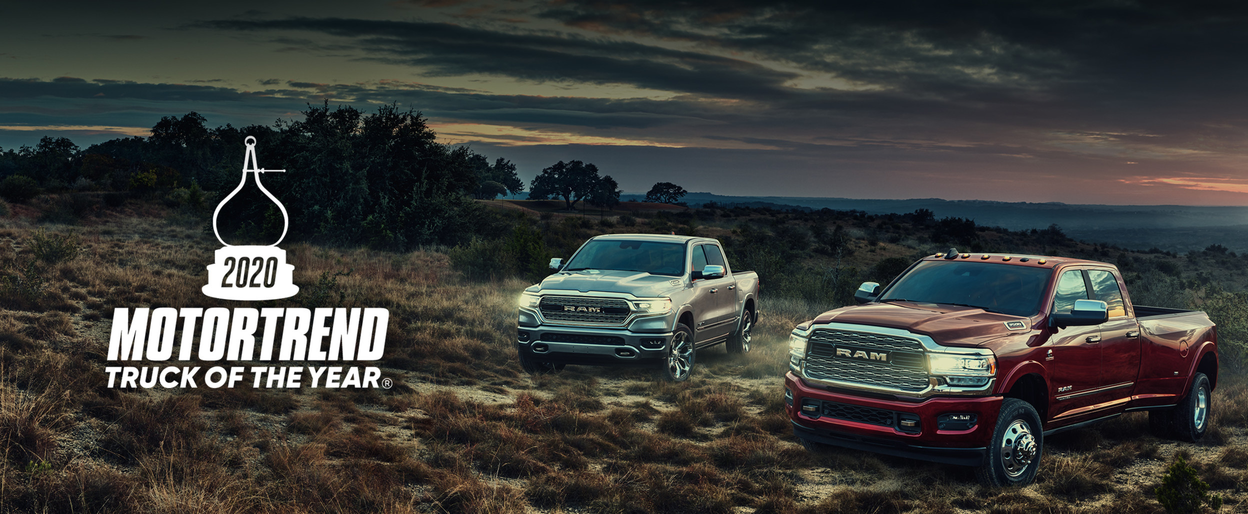 The 2020 Ram 3500 and 1500 parked on in the grass.