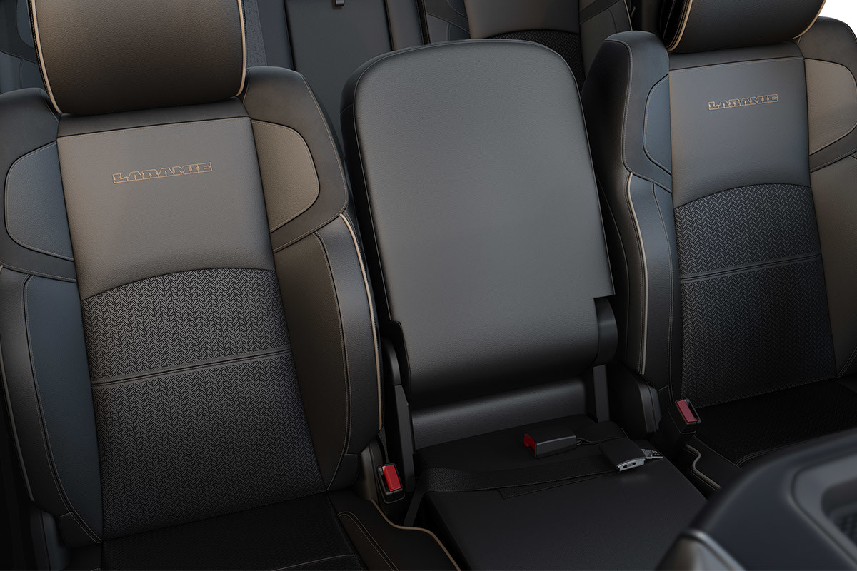 An interior view of premium leather captain’s chairs and middle bench seat inside the 2021 Ram 3500.
