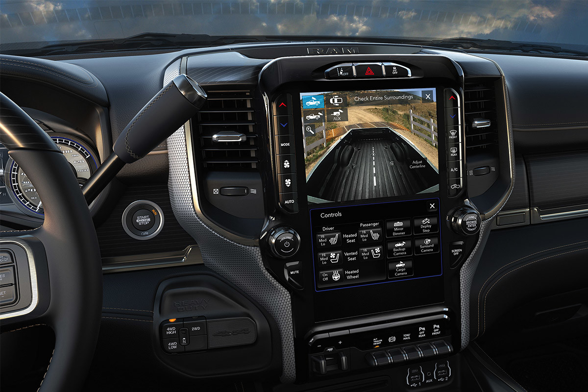 A close-up of a Uconnect multimedia system touchscreen displaying the view of the cargo bed of the 2021 Ram 3500 thanks to the Centre High-Mounted Stop Lamp Cargo View Camera.