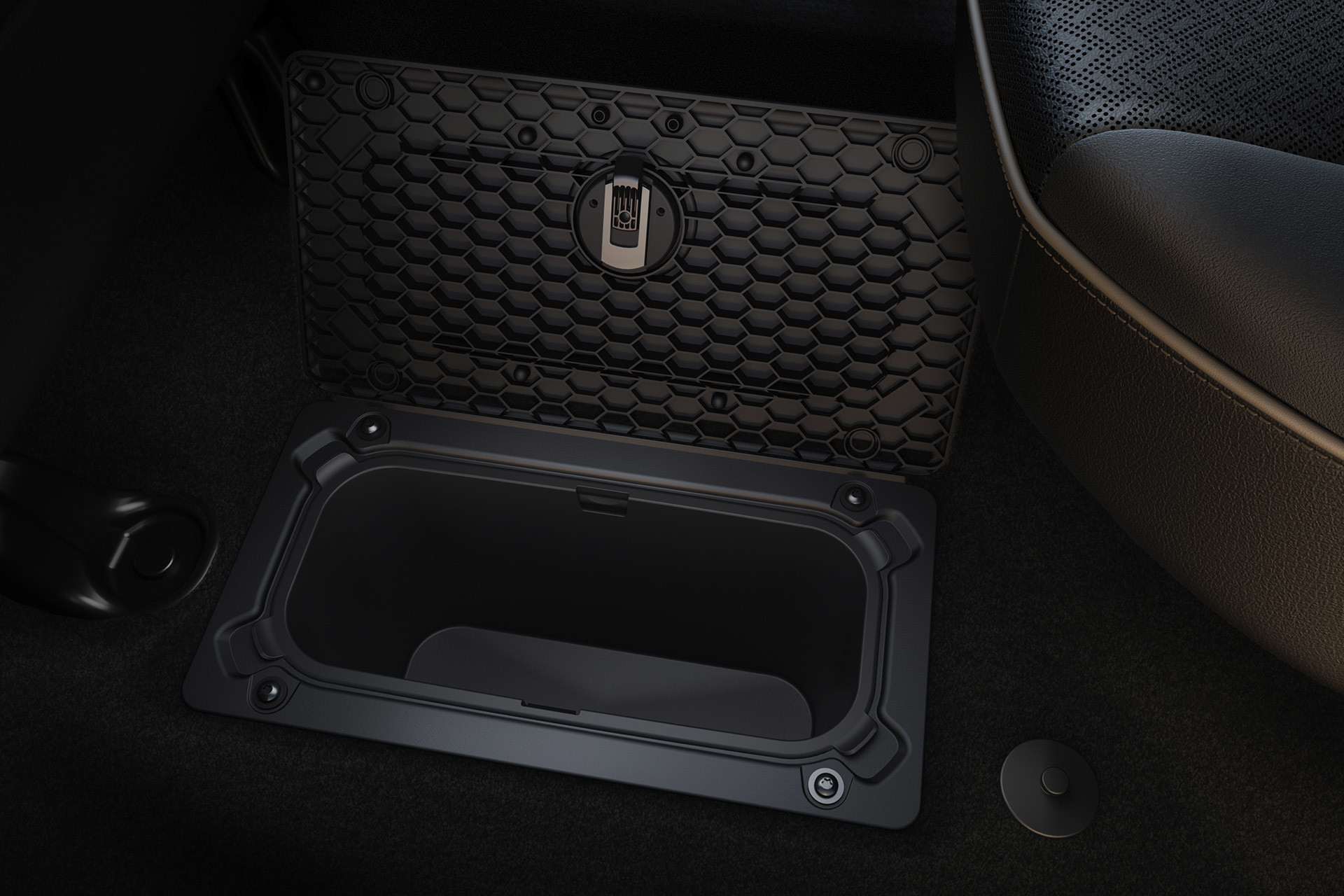A close-up of the in-floor storage compartment inside the Ram 3500, open to reveal the additional space it provides.