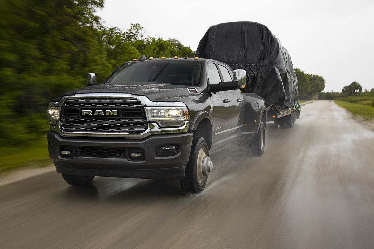Front view of a 2022 Ram 3500, towing a large trailer.