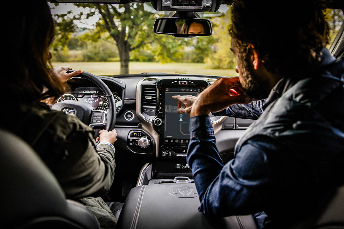 A driver and a passenger sitting inside a 2022 Ram 3500.