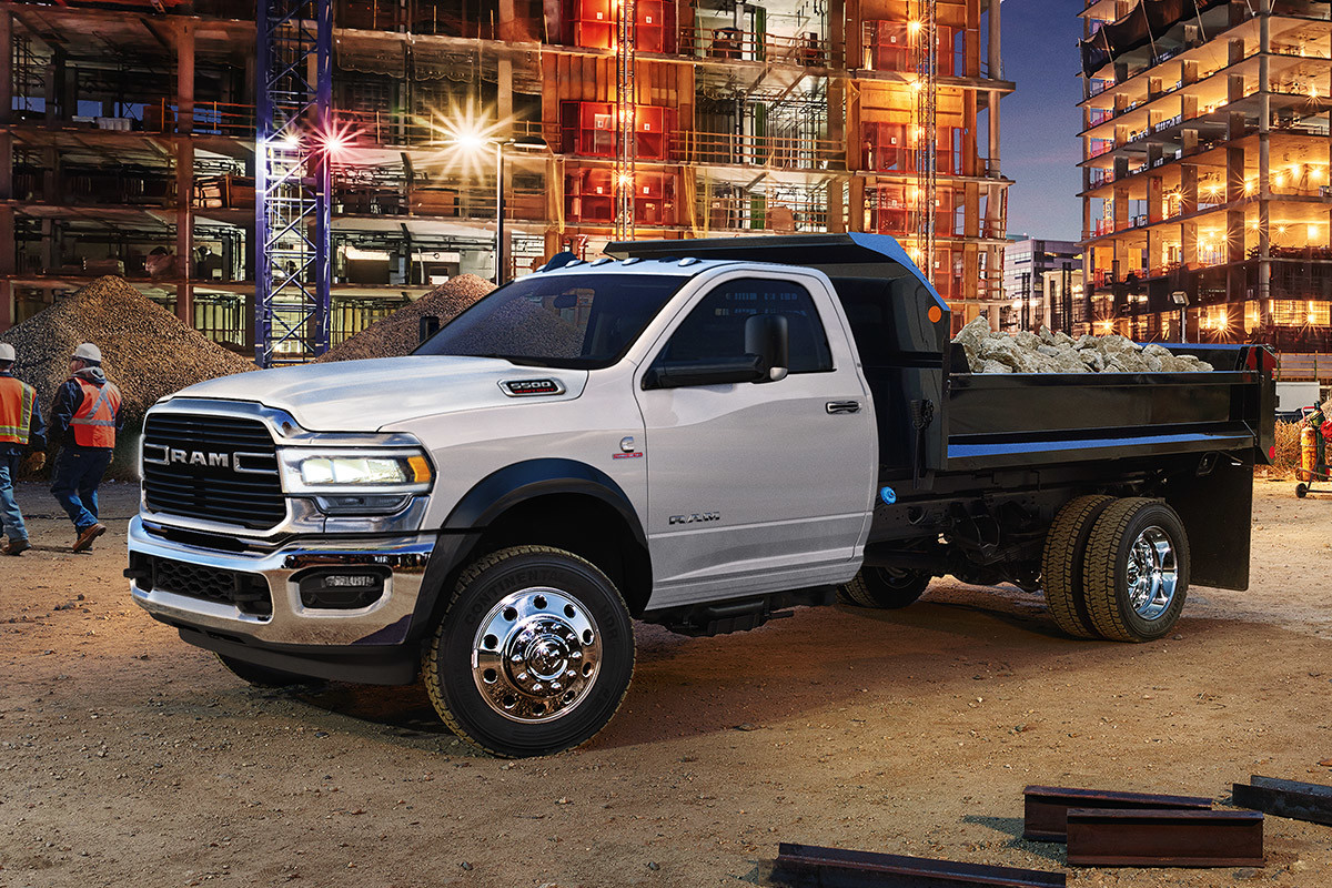 The white Ram 2020 Chassis Cab is parked in a building construction site at night