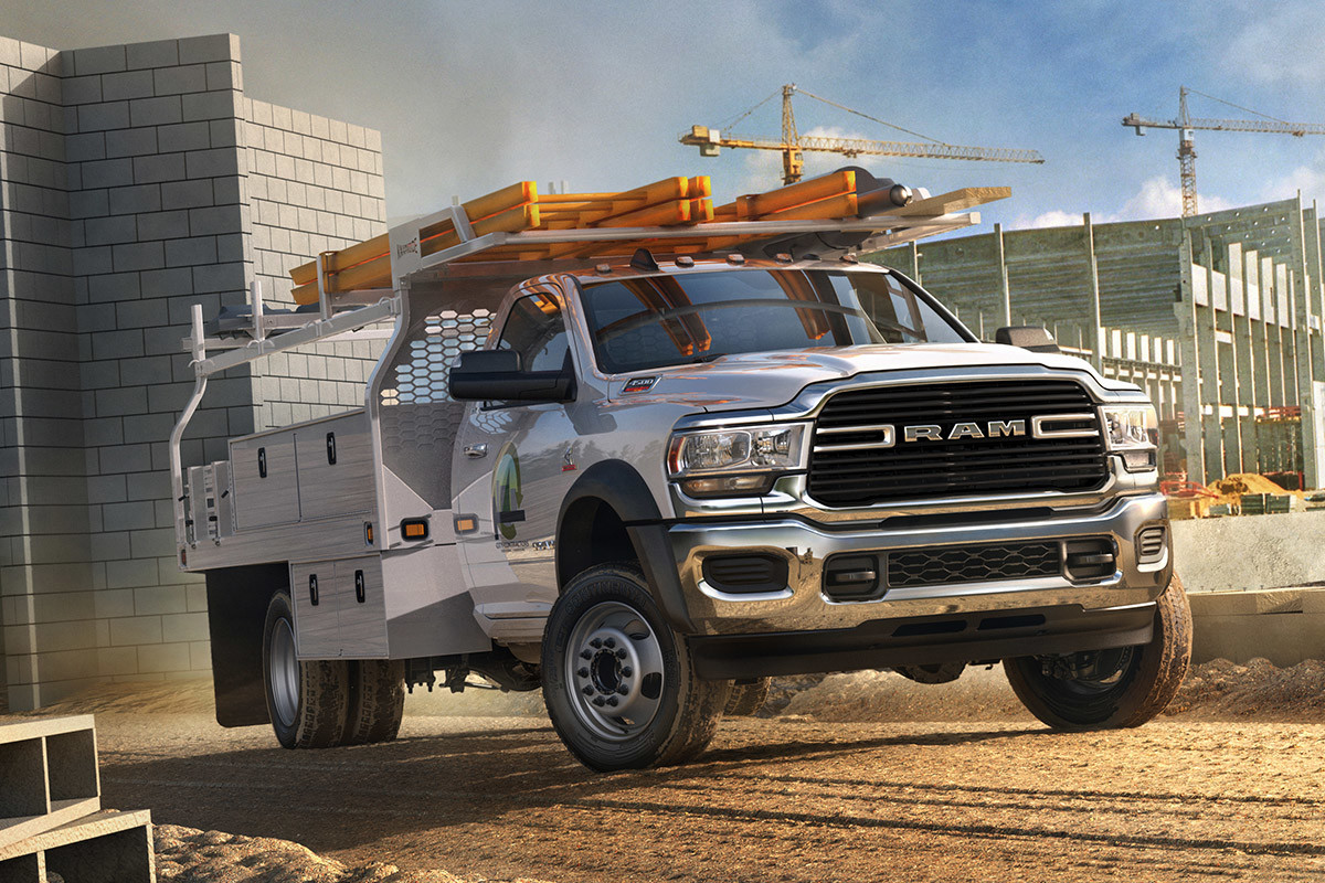 The white 2020 Ram Chassis Cab being driven in a construction site