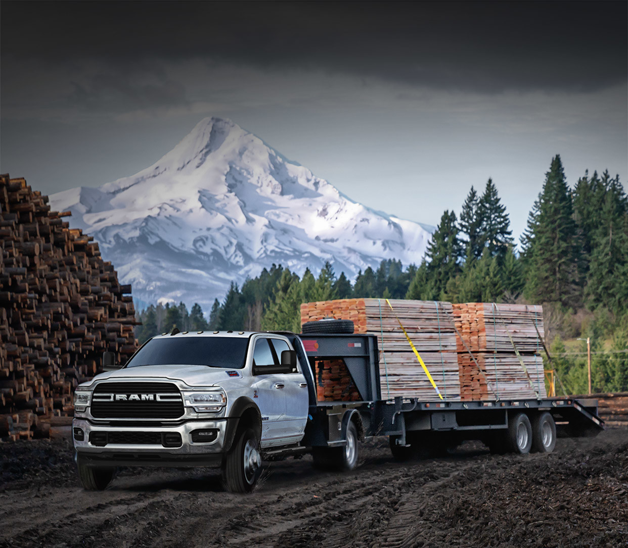 The white 2020 Ram Chassis Cab towing lumbers in construction site