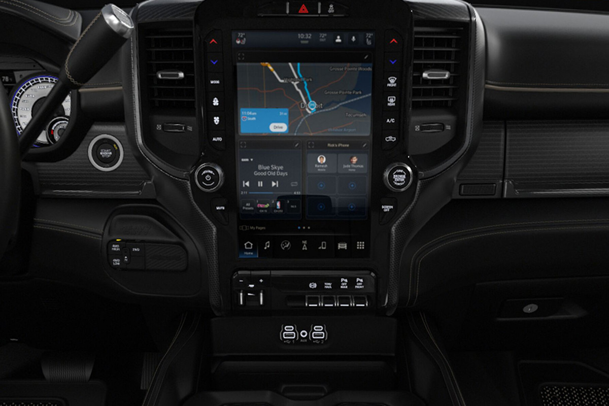 Close up view of the Uconnect 5 Multimedia touchscreen showing split-screen navigation, music player, and user profiles inside the 2022 Ram Chassis Cab.