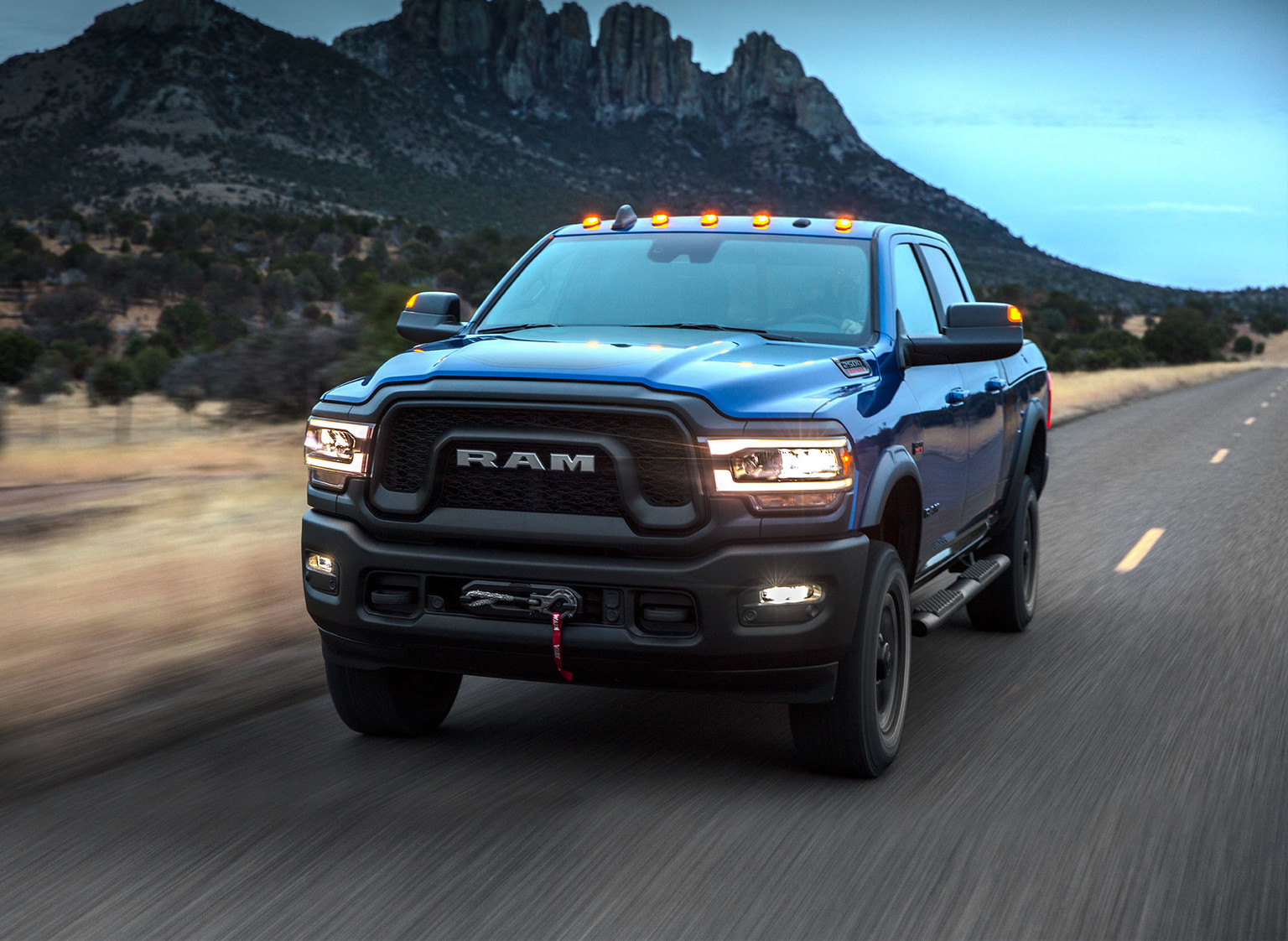 Blue 2019 Ram HD pickup Truck Driving Though the Plains and Mountains