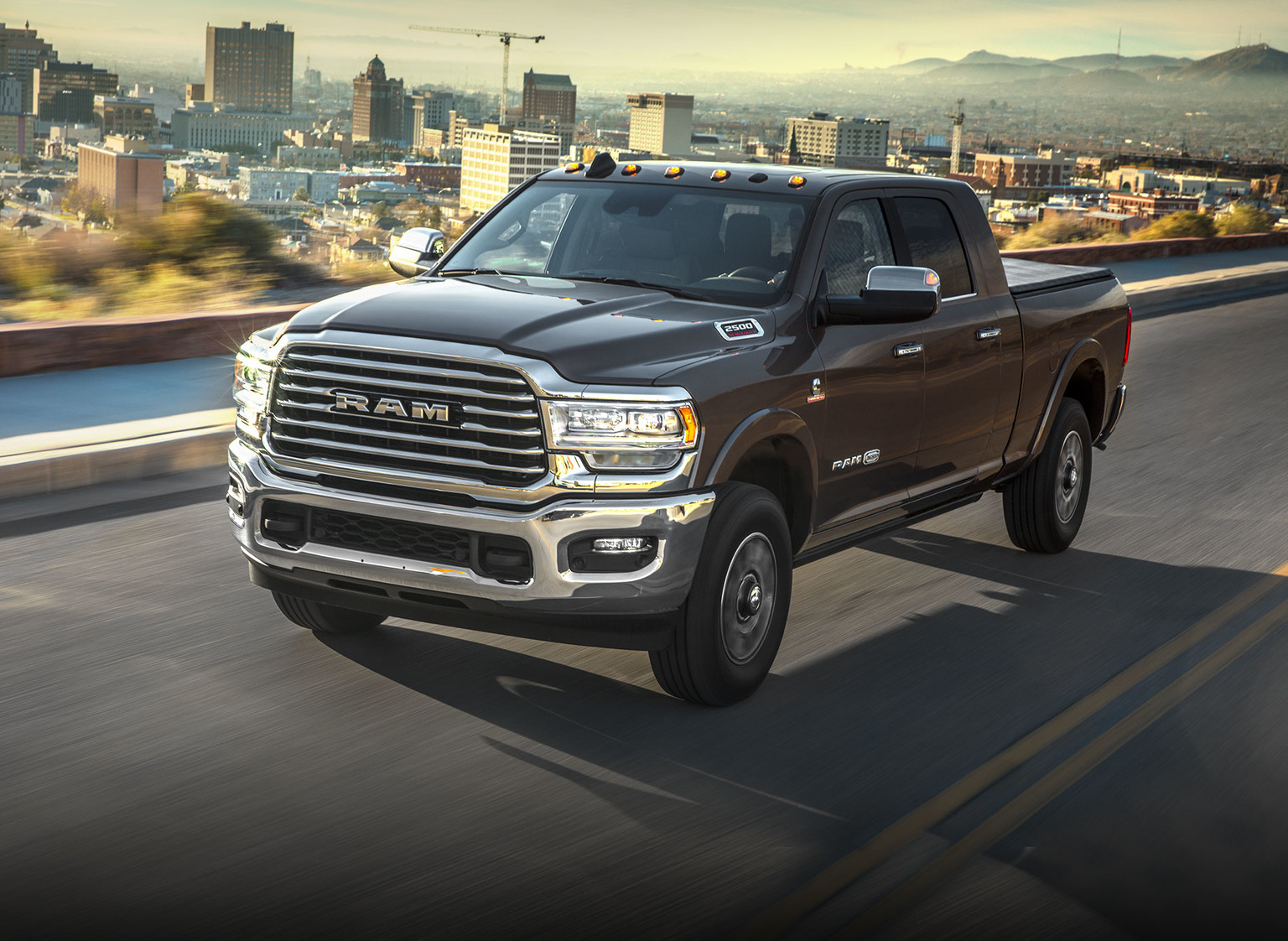 Brown 2019 Ram HD Truck being driven on a road in an urban area