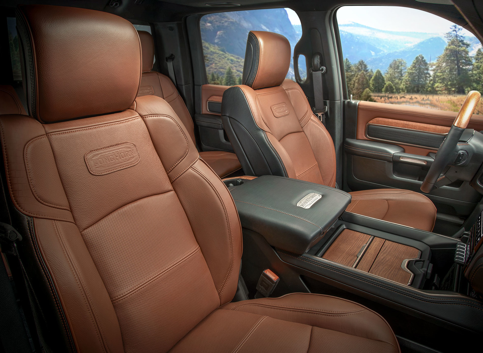 Brown front leather seats and black leather armrest of 2019 Ram HD pickup truck