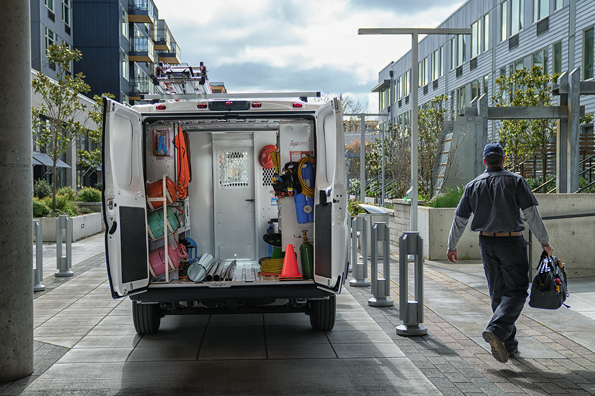 Rear view of the 2020 Ram ProMaster with rear doors opened in an urban area