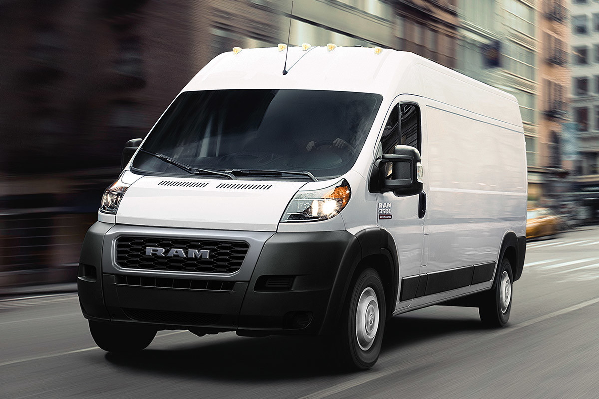 Ram ProMaster driving down a city road.