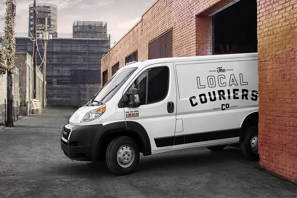 Vue latérale d’un Ram ProMaster 2022, illustré en blanc, sortant du stationnement extérieur d’un édifice