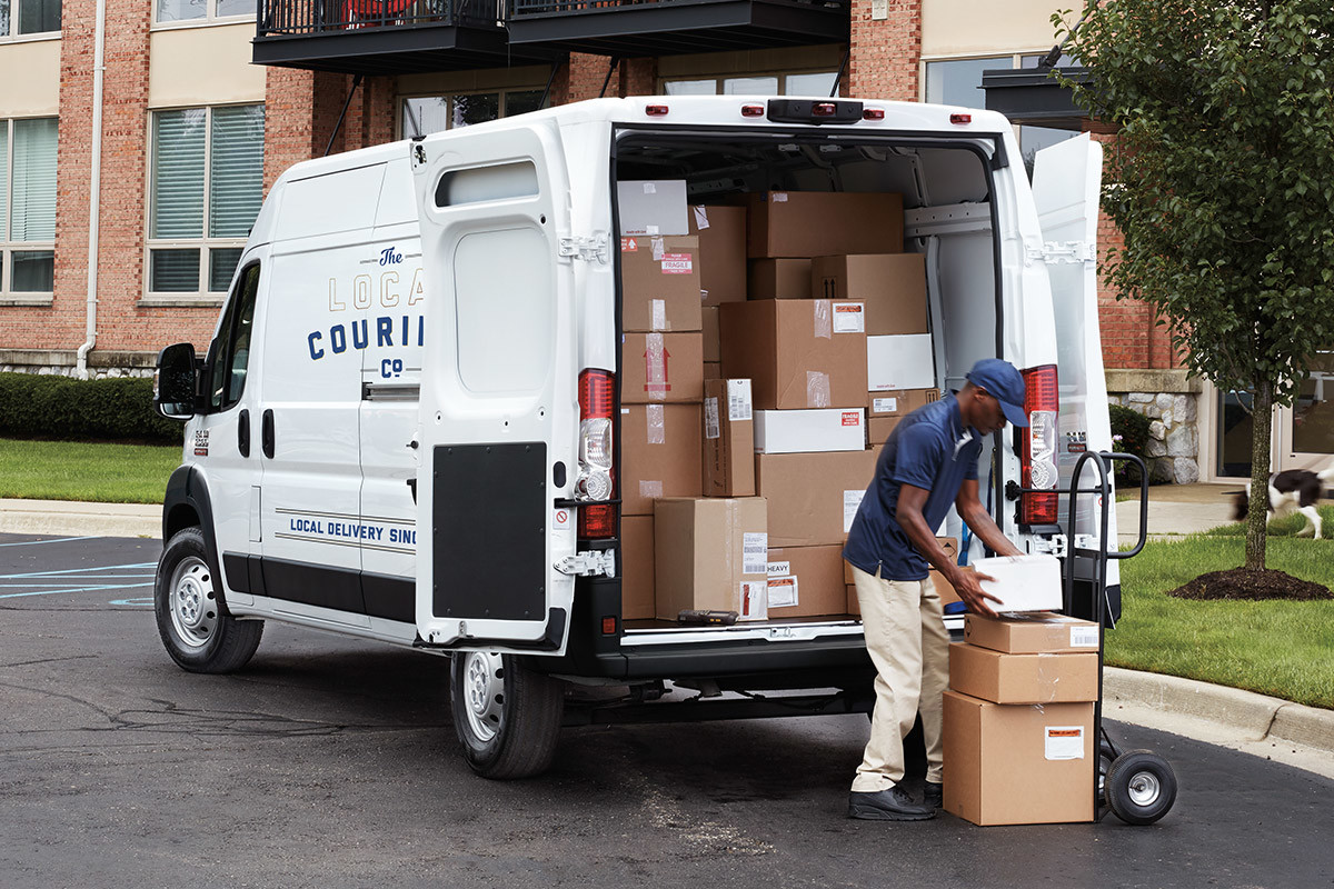 Personne chargeant des boîtes dans un Ram ProMaster 2022 garé