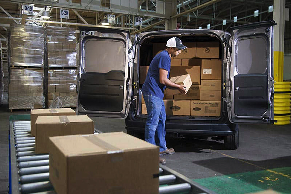 2019 Ram ProMaster City cargo doors open, being loaded by a worker