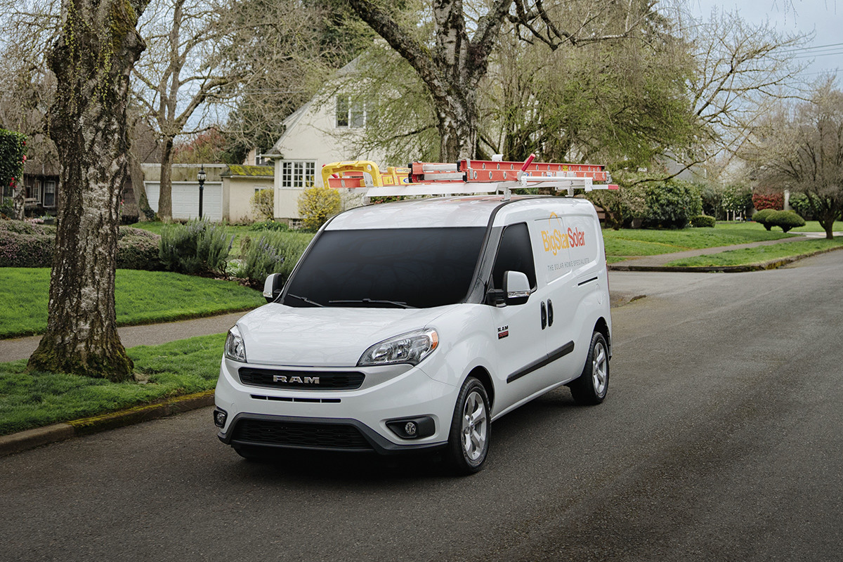 2019 Ram ProMaster City® driving down city street, shown in white