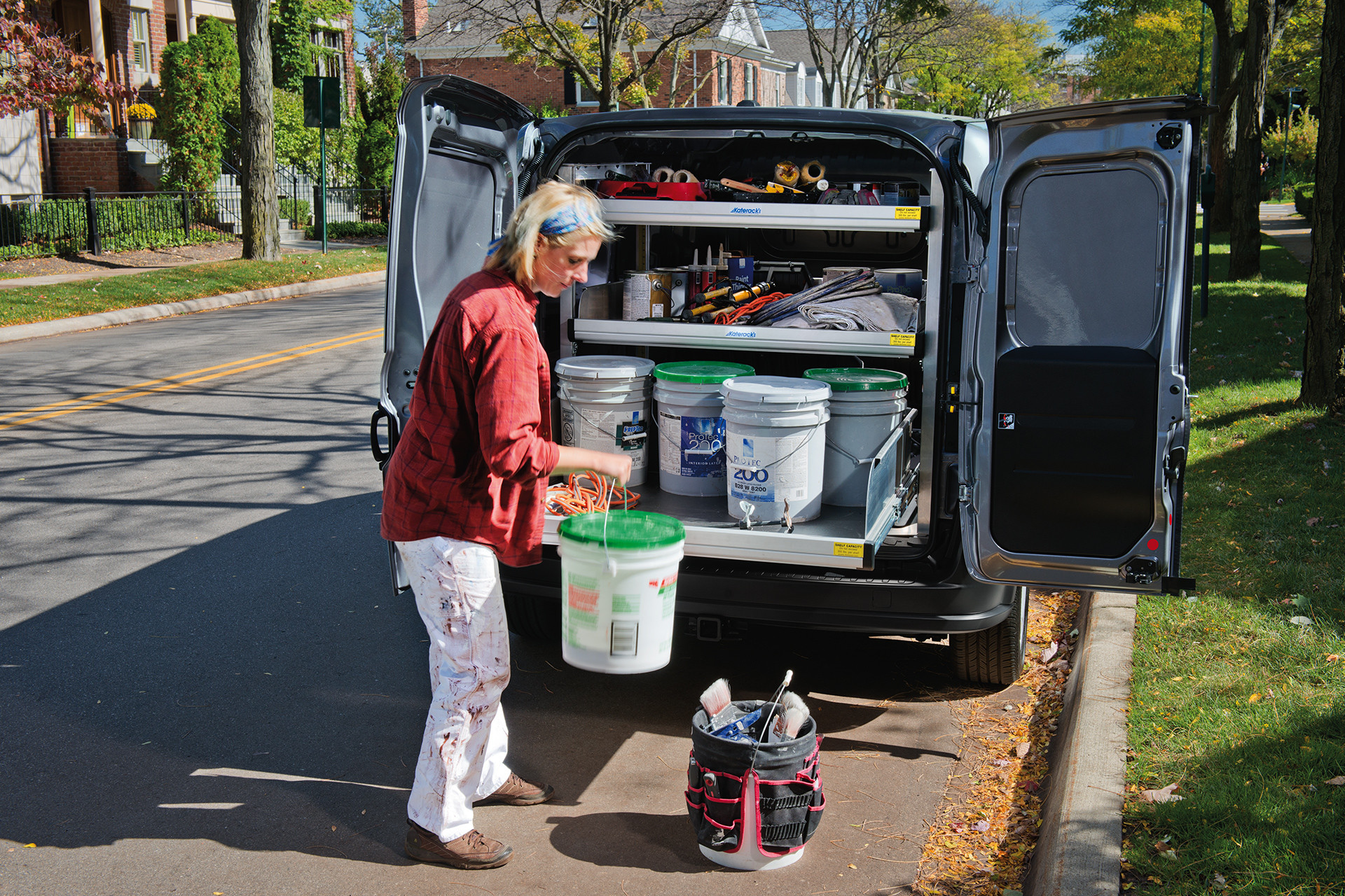 2019 Ram ProMaster City parked on city street, rear doors open, worker unloading tools