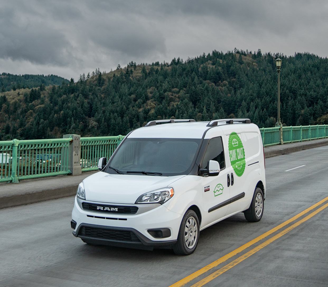 2019 Ram ProMaster City<sup>®</sup> driving over a bridge, shown in white