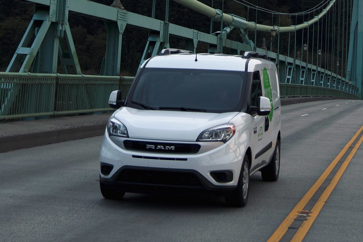 White 2021 Ram ProMaster City driving across a suspension bridge.