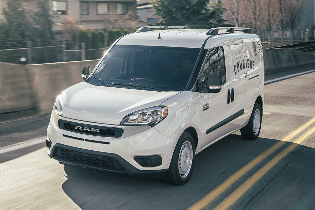 A white 2022 Ram ProMaster City being driven down a road.