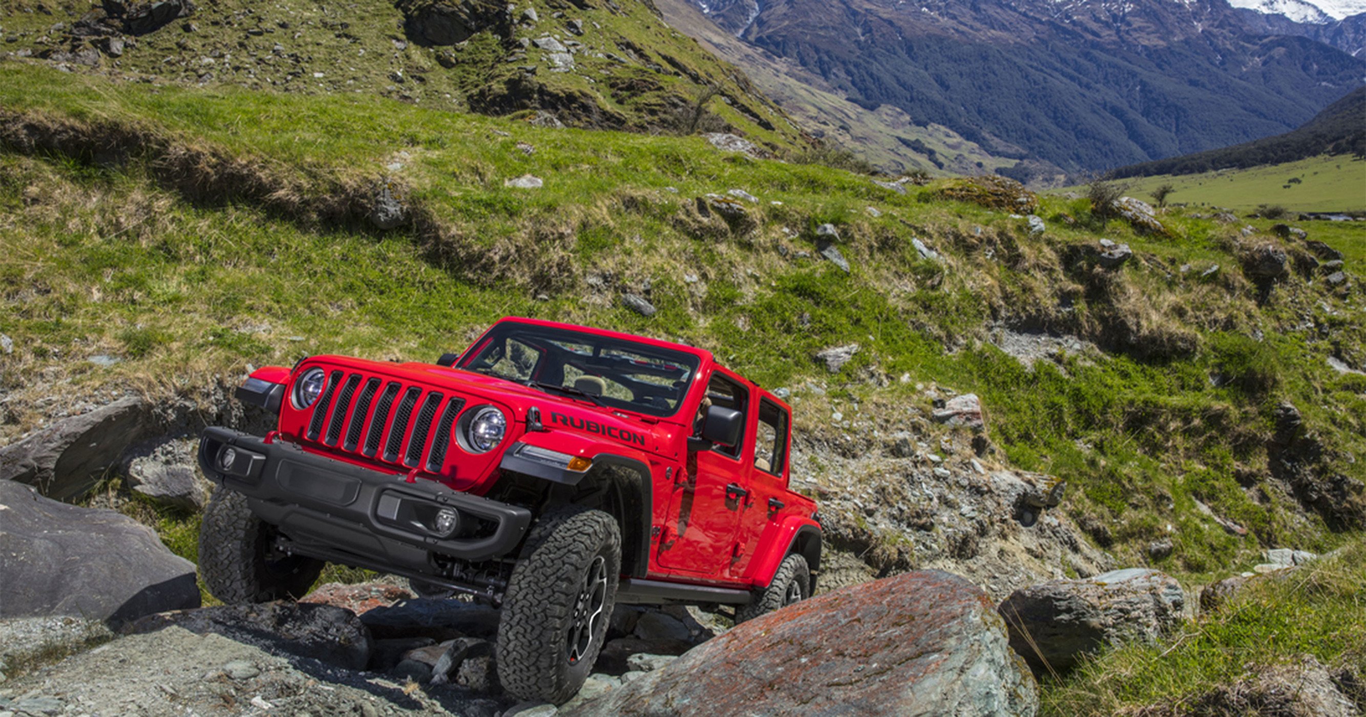 Front view of Jeep Wrangler with mountains in distance.