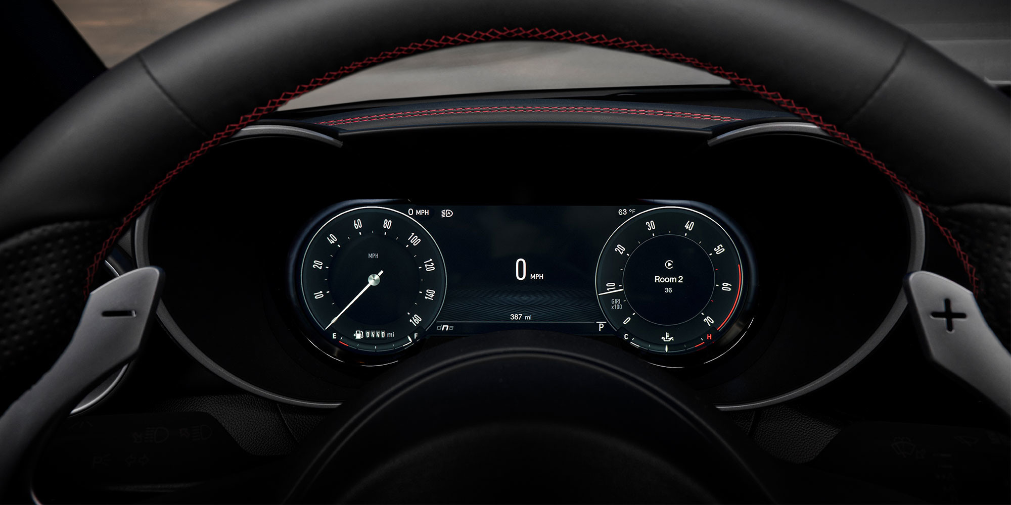 Vue intérieure d'un véhicule Alfa Romeo 2025, se concentrant sur le groupe d'instruments numériques derrière le volant.