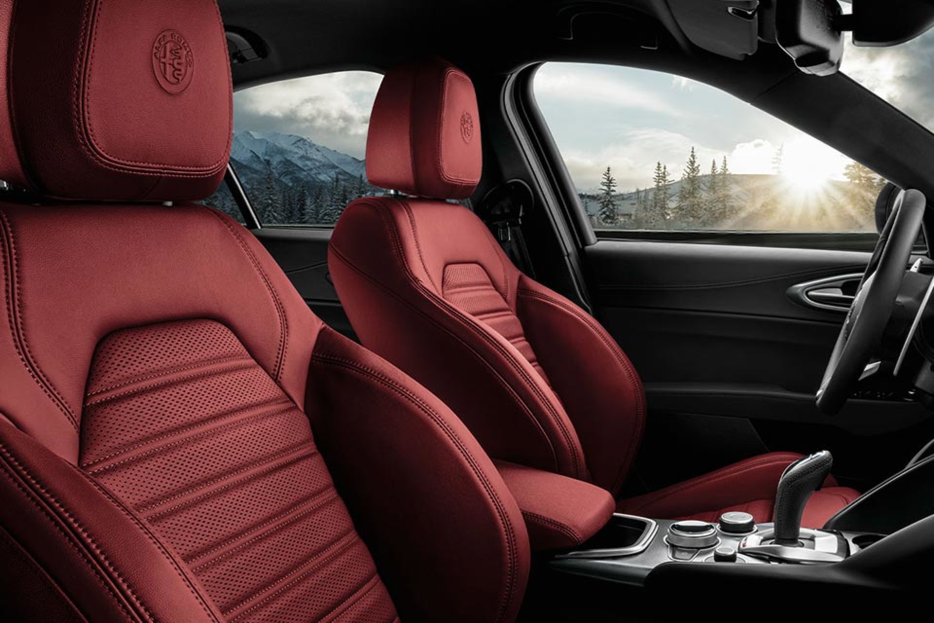 Interior of the 2025 Alfa Romeo Giulia with leather seats, showcasing a view of a snowy landscape through the windows.